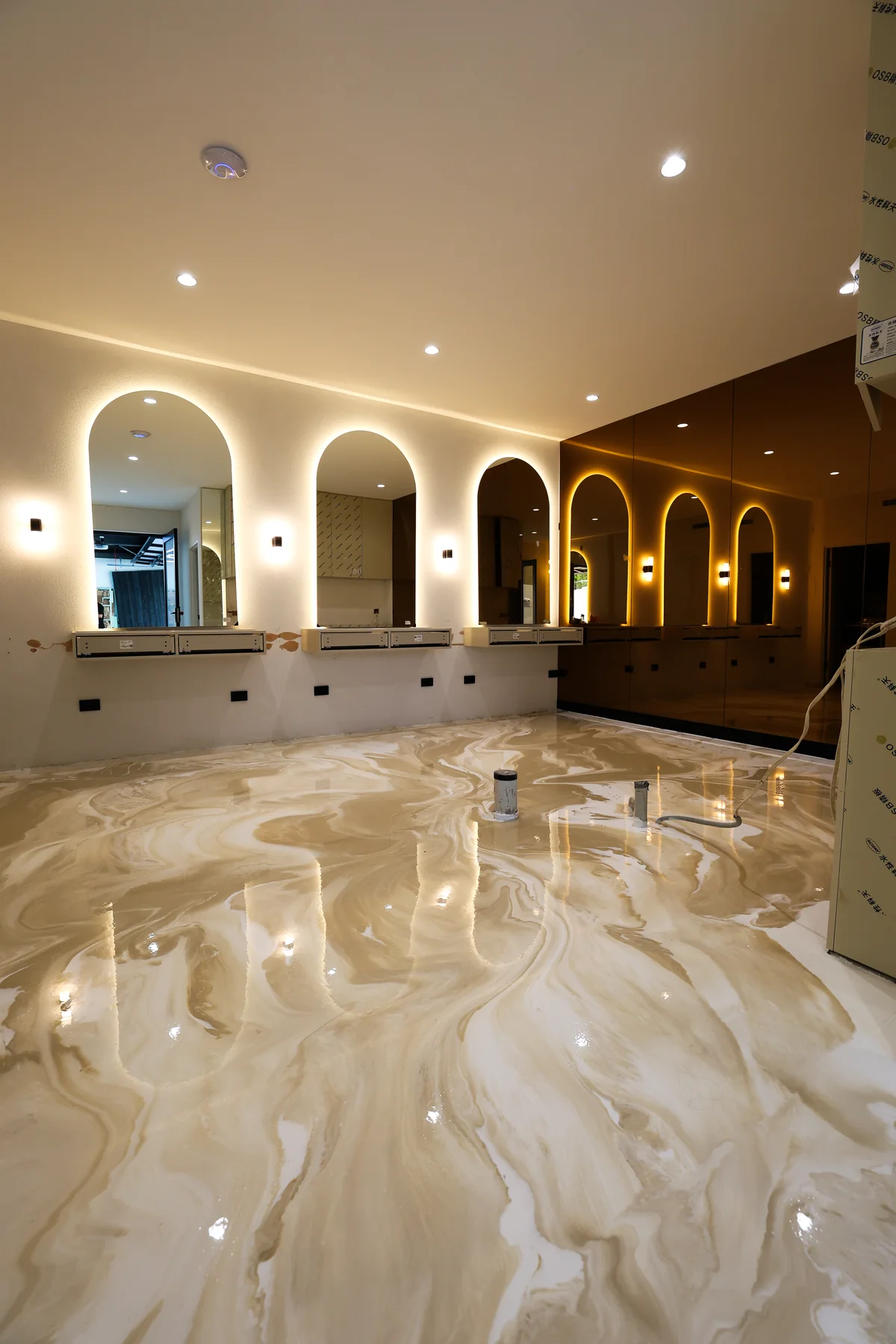Cream metallic marble floor in an arched venue interior